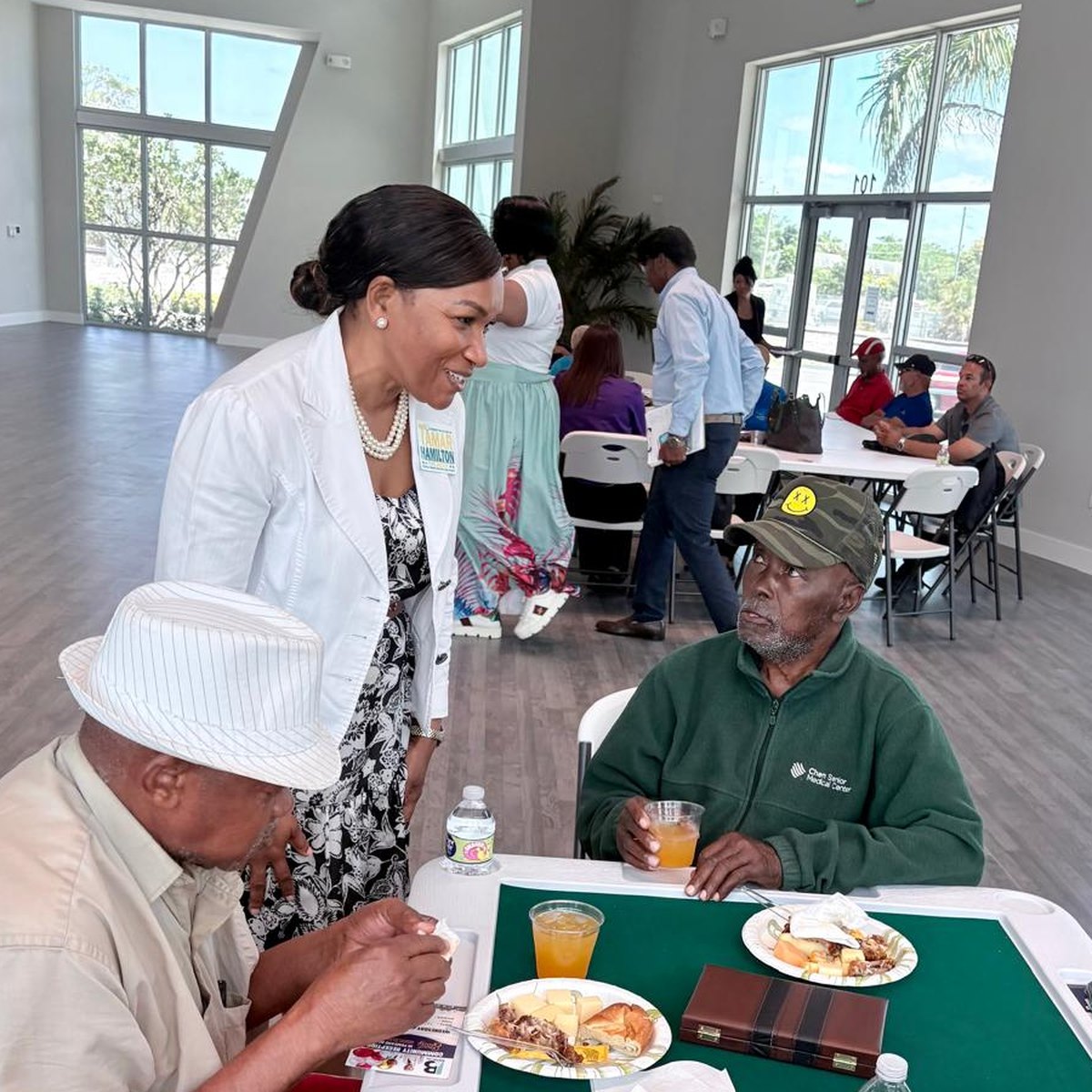 Tamar Hamilton playing dominoes with community members