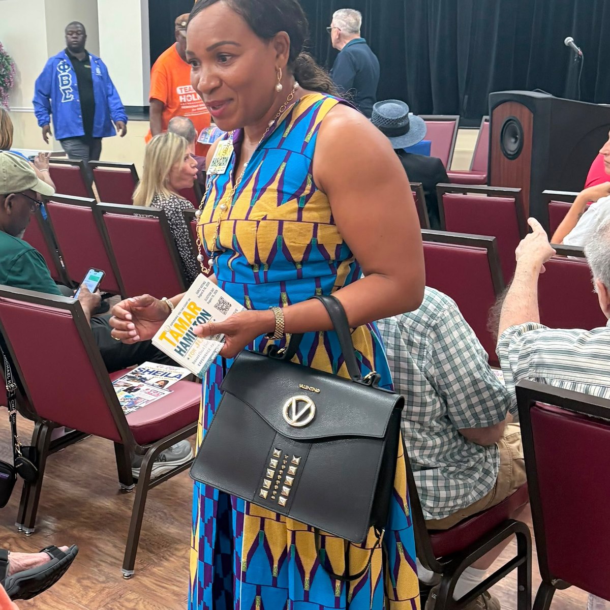 Tamar Hamilton speaking with a voter at a candidate forum